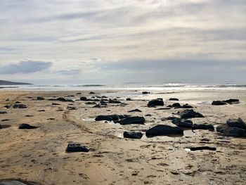 Rocks on beach against sky