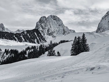 Scenic view of snow covered mountains against sky