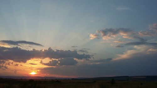 Scenic view of landscape against sky at sunset