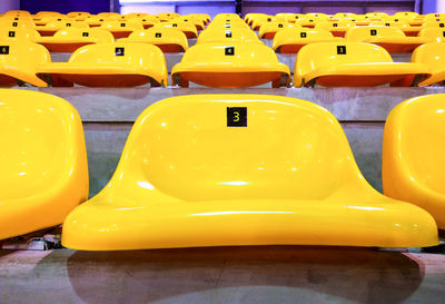 Close-up of yellow seats in row