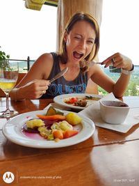 Midsection of woman sitting on table