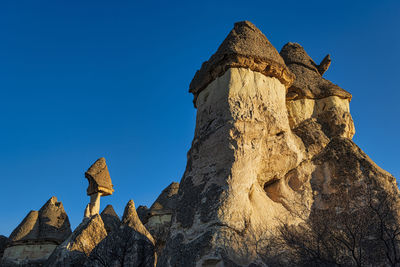 Low angle view of rock formation against blue sky