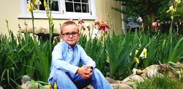 Portrait of man sitting on plants