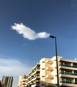 Low angle view of modern buildings against blue sky