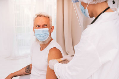 Doctor injecting vaccine to patient