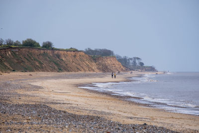 Scenic view of beach against clear sky