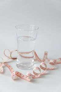 Close-up of drink on table against white background