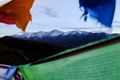 Close-up of snow on mountain against sky