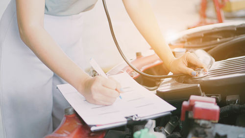 Midsection of woman working on table