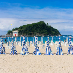 Graffiti on beach against blue sky