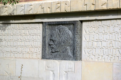Close-up of sculpture on wall of building