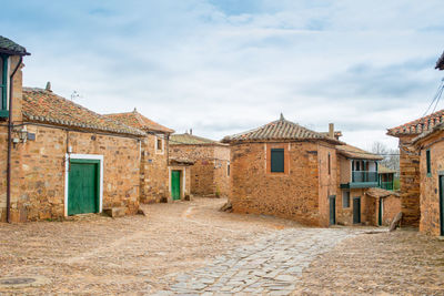 Residential buildings in town against sky