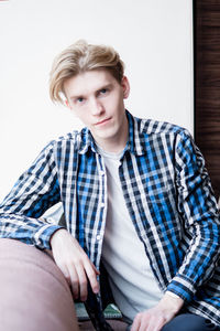 Portrait of young man sitting outdoors