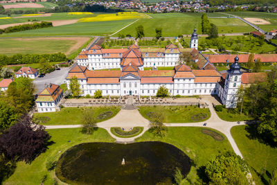 High angle view of trees and houses on field