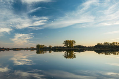 The reflection of beautiful clouds in the lake's surface, evening autumn view