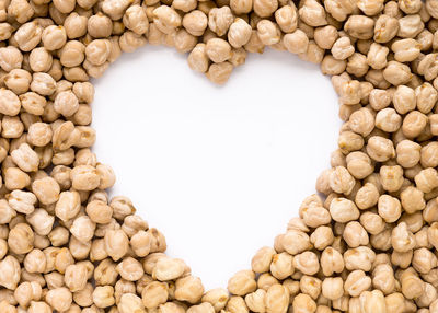 Close-up of heart shape amid chickpeas