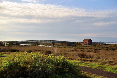 Built structure on field against sky