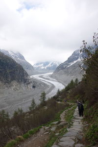 Scenic view of mountains against cloudy sky