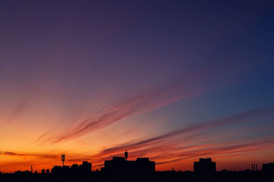 Silhouette buildings against sky during sunset