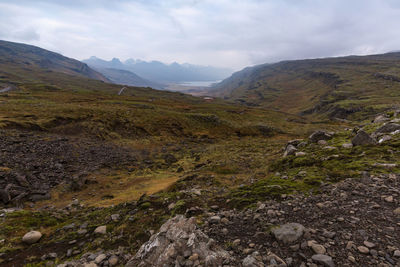 Scenic view of mountains against cloudy sky