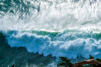 Panoramic shot of waves breaking against sea