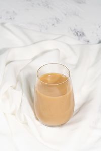 High angle view of tea cup on bed