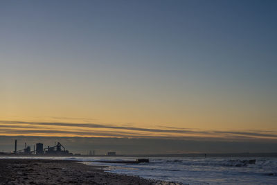 Scenic view of sea against clear sky during sunset