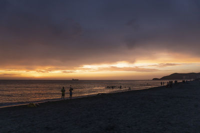 Scenic view of beach against sky during sunset