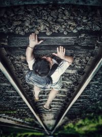 High angle view of woman on railroad tracks