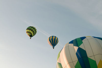 Low angle view of hot air balloons flying in sky