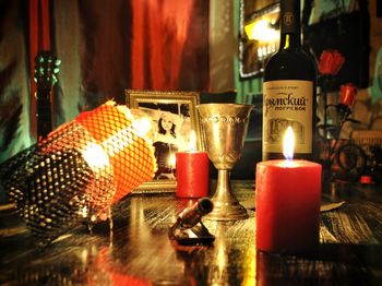 Close-up of illuminated tea light candles on table in restaurant