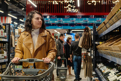 Portrait of young woman standing in store