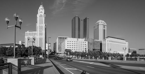 Street amidst buildings against sky in city