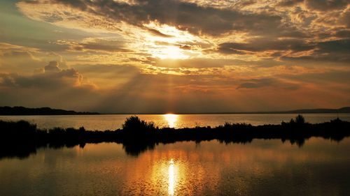 Scenic view of lake against sky during sunset