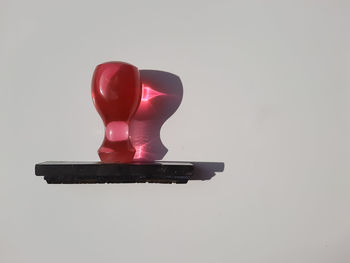 Close-up of red toy against white background