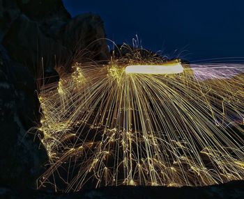 Low angle view of illuminated lights against sky at night