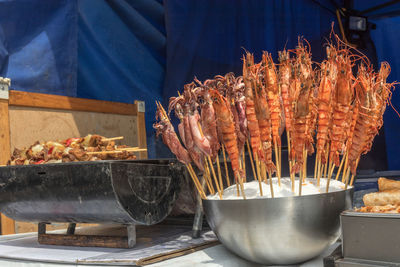 Food on barbecue grill at market stall
