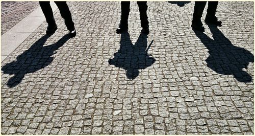 Shadow of people on footpath