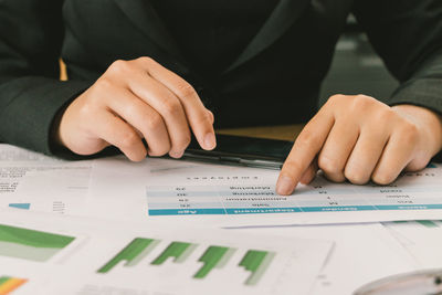 Midsection of man working on table