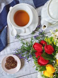 A cup of tea and some pieces of cookies