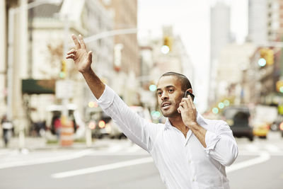 Man on the phone hailing taxi