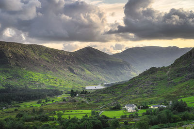 Small cottage surrounded by forest, lake and river in black valley. ring of kerry, ireland