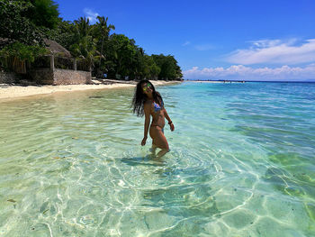 Full length of young woman in bikini on beach
