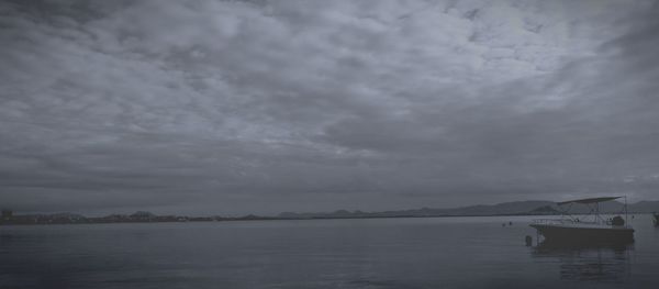 Scenic view of sea against storm clouds