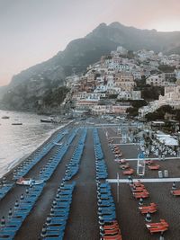 High angle view of chairs arranged at beach against sky