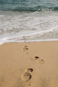 High angle view of footprints on beach