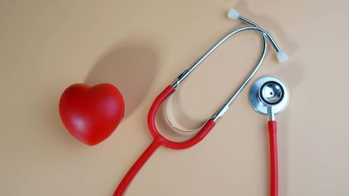 High angle view of heart shape on table against white wall