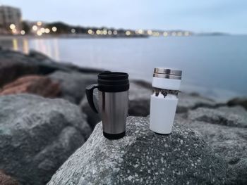 Close-up of water on rock at beach against sky, dawn coffee