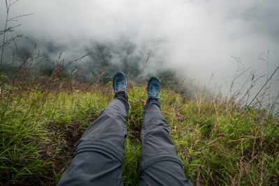 Low section of person wearing shoes on land