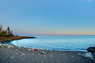 Scenic view of sea against clear blue sky
